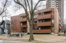 Multi-story building featuring horizontal brown siding and vertical brick accents - 303 10026 112 Street, Edmonton, AB  - Outdoor 