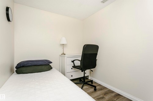 Neutral-toned room featuring wood-finish flooring - 303 10026 112 Street, Edmonton, AB - Indoor Photo Showing Bedroom