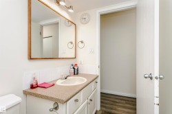 Bathroom vanity with a composite countertop, an undermount sink, and a framed mirror - 