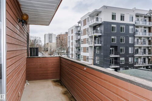 Private outdoor balcony with wood-finish siding and a textured ceiling - 303 10026 112 Street, Edmonton, AB - Outdoor