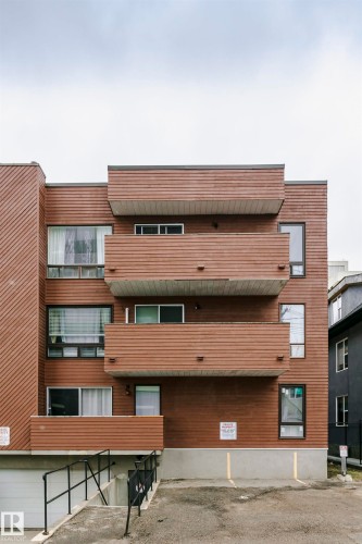 Multi-level apartment building featuring horizontal wood-finish siding - 303 10026 112 Street, Edmonton, AB - Outdoor With Exterior