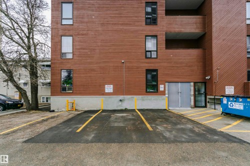 Exterior building featuring horizontal wood-finish siding and multiple windows with dark frames - 303 10026 112 Street, Edmonton, AB - Outdoor With Exterior