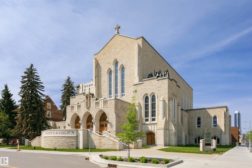 Stone-clad building featuring arched entryways and tall, pointed arch windows - 303 10026 112 Street, Edmonton, AB - Outdoor With Facade