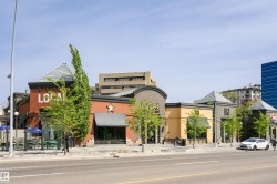 Street-level commercial buildings featuring varied facades and prominent storefronts - 