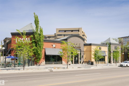 Commercial building featuring brick and stucco facades with multiple storefronts and awnings - 303 10026 112 Street, Edmonton, AB - Outdoor