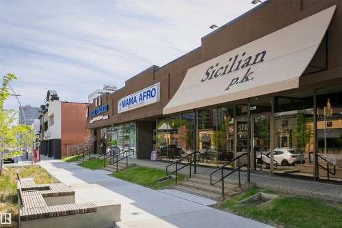 Commercial storefront with a large awning, expansive display windows, and double-door entry - 303 10026 112 Street, Edmonton, AB - Outdoor