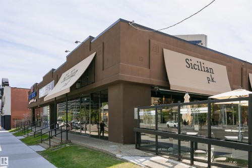 Commercial storefront featuring a brown stucco exterior - 303 10026 112 Street, Edmonton, AB - Outdoor