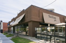 Commercial storefront featuring a brown stucco exterior - 