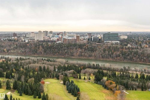 Expansive aerial perspective featuring a golf course, river, and urban skyline - 303 10026 112 Street, Edmonton, AB - Outdoor With View