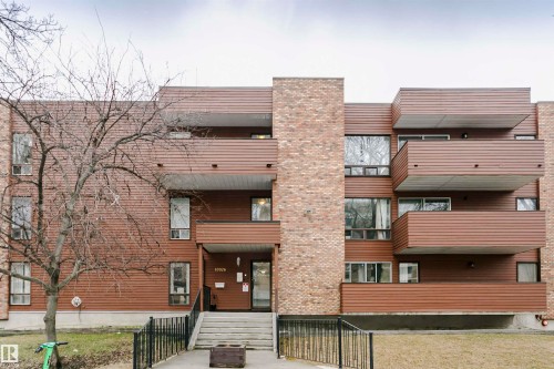 Multi-level building exterior featuring brick and wood-finish siding - 303 10026 112 Street, Edmonton, AB - Outdoor With Exterior