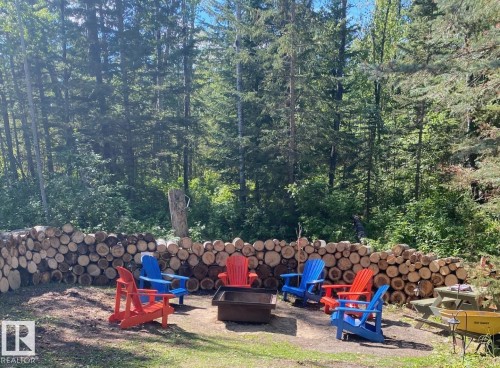 Outdoor gathering area featuring a central fire pit - 650031 Range Road 185, Rural Athabasca County, AB 