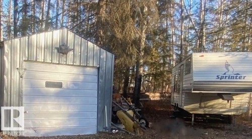 Corrugated metal shed with a roll-up garage door - 650031 Range Road 185, Rural Athabasca County, AB 
