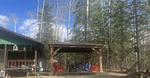 Outdoor wooden gazebo featuring a shingled roof, exposed beam construction, and a concrete pad - 650031 Range Road 185, Rural Athabasca County, AB 