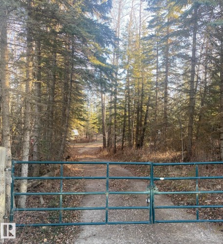 Gated entry to a private, tree-lined driveway - 650031 Range Road 185, Rural Athabasca County, AB 