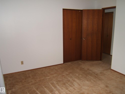 Neutral wall paint with carpet flooring - 5030 52 Avenue, Andrew, AB - Indoor Photo Showing Other Room