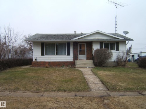 White siding exterior with brick facade accents - 5030 52 Avenue, Andrew, AB - Outdoor With Facade