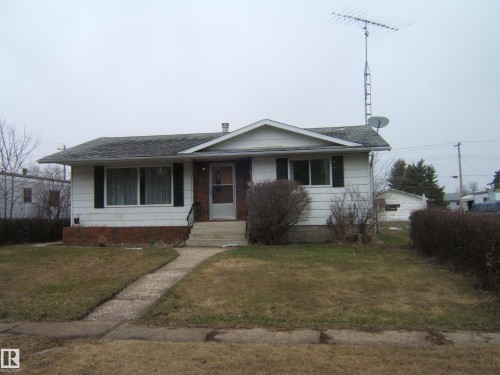 Single-story residence featuring white siding, dark shutters, and a covered entry - 5030 52 Avenue, Andrew, AB - Outdoor