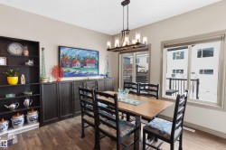 Dining area featuring wood-finish flooring and neutral wall tones - 