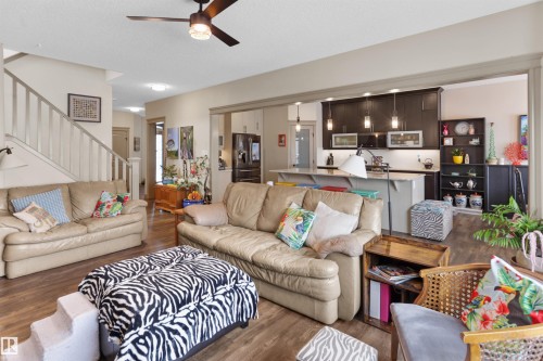 Expansive living area featuring wood-finish flooring and a ceiling fan with integrated lighting - 97 Astoria Point(E), Devon, AB - Indoor Photo Showing Living Room