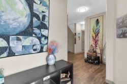 Hallway featuring wood-finish flooring, recessed lighting, and neutral wall tones - 