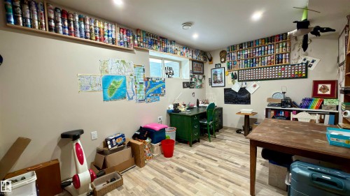 Finished basement room featuring wood-look flooring, recessed lighting, and a window - 97 Astoria Point(E), Devon, AB - Indoor Photo Showing Other Room