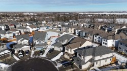 New construction community featuring various two-story homes with attached garages, shingled roofs, and diverse exterior finishes - 