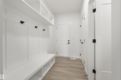 Entryway featuring built-in white board-and-batten storage, integrated bench seating, and overhead cubbies - 162 Caldeon Crescent, Spruce Grove, AB - Indoor Photo Showing Other Room