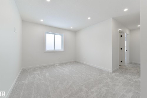 Spacious room featuring light gray carpeting, recessed ceiling lighting, a white window frame, and white baseboards - 162 Caldeon Crescent, Spruce Grove, AB - Indoor Photo Showing Other Room
