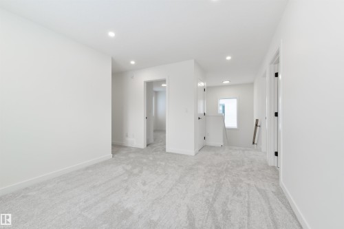 Expansive interior space featuring light gray carpet, recessed lighting, white walls, white trim, and matte black door hardware - 162 Caldeon Crescent, Spruce Grove, AB - Indoor Photo Showing Other Room