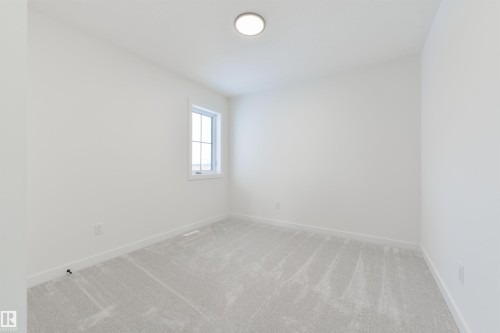 Interior room featuring light gray carpeting, white walls, a single window, white baseboards, and a flush-mount ceiling light - 162 Caldeon Crescent, Spruce Grove, AB - Indoor Photo Showing Other Room