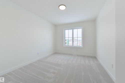 Bright room featuring light grey carpeting, white baseboards, a single window with white trim, and a flush-mount ceiling light - 162 Caldeon Crescent, Spruce Grove, AB - Indoor Photo Showing Other Room
