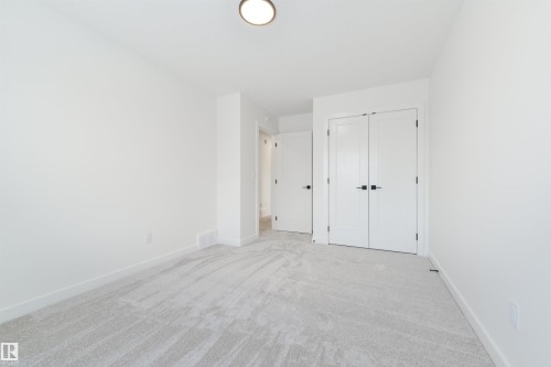 Spacious room featuring light gray carpeting, white walls, white trim, and a ceiling-mounted light fixture - 162 Caldeon Crescent, Spruce Grove, AB - Indoor Photo Showing Other Room