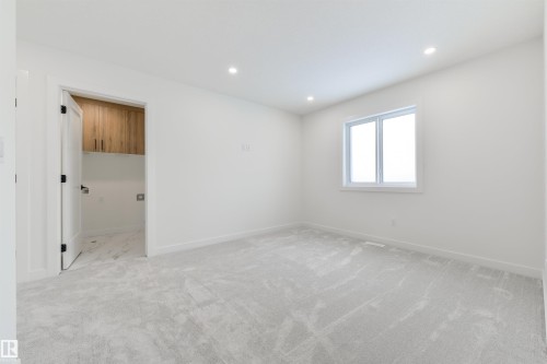 Spacious room featuring light gray carpeting, recessed ceiling lighting, and a white-trimmed window - 162 Caldeon Crescent, Spruce Grove, AB - Indoor Photo Showing Other Room
