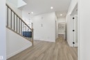 Contemporary interior featuring light wood-finish flooring and a staircase with a light wood handrail and black metal balusters - 162 Caldeon Crescent, Spruce Grove, AB  - Indoor Photo Showing Other Room 