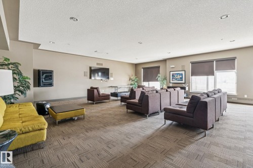 This spacious common room features recessed lighting, windows with blinds, and carpeted flooring - #321 63 Inglewood Park, Calgary, AB - Indoor Photo Showing Other Room