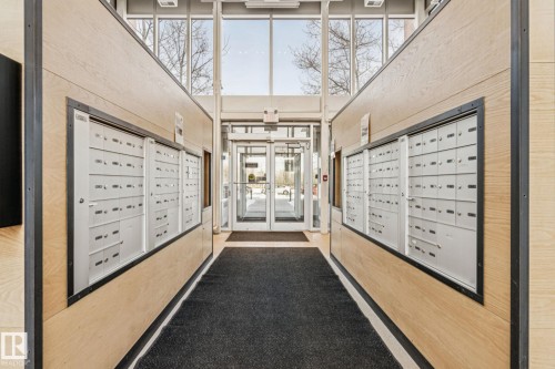 The property features a bright and airy entrance with light wood paneling, extensive window walls, and a glass-paneled entry door - #321 63 Inglewood Park, Calgary, AB - Indoor Photo Showing Other Room