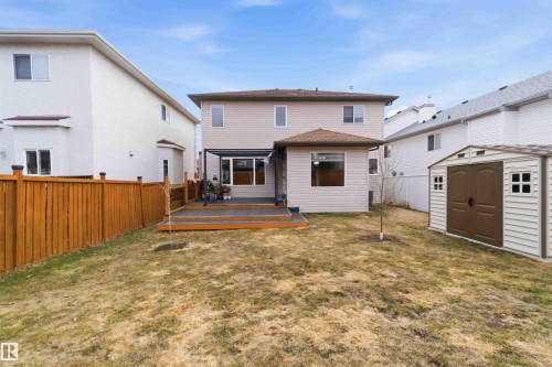 Backyard featuring a multi-level wood deck with a pergola, a storage shed, and a privacy fence - 16412 60 Street, Edmonton, AB - Outdoor With Exterior