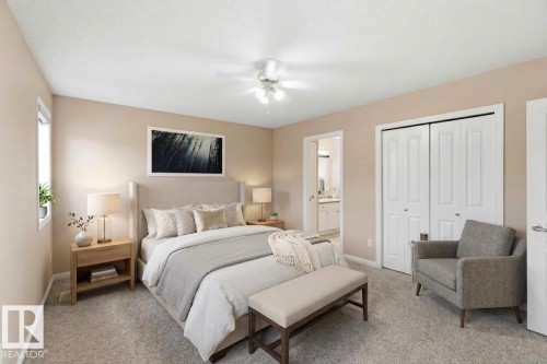 Carpeted bedroom featuring a ceiling fan, a window, bifold closet doors, and an open doorway to an adjacent space - 16412 60 Street, Edmonton, AB - Indoor Photo Showing Bedroom