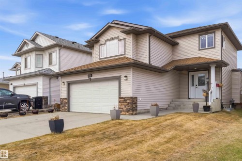 Exterior facade featuring neutral-toned siding and a prominent attached garage - 16412 60 Street, Edmonton, AB - Outdoor