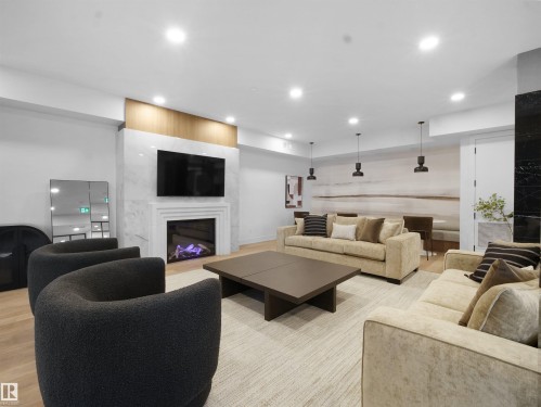 402 7459 May Common, Edmonton, AB - Indoor Photo Showing Living Room With Fireplace