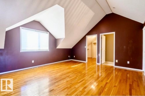 Spacious room featuring sloped ceilings, a dormer window, and wood-finish flooring - 18633 122 Avenue, Edmonton, AB - Indoor Photo Showing Other Room