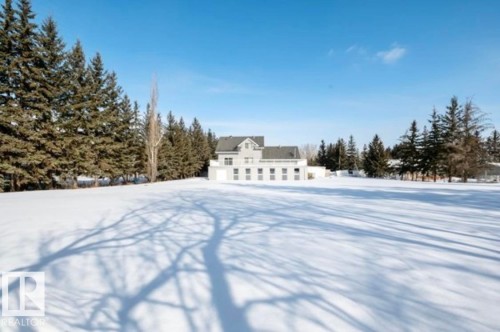 Expansive snow-covered lawn surrounding a multi-story residence with a gray roof and numerous windows - 18633 122 Avenue, Edmonton, AB - Outdoor With View