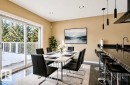 Virtually staged. Dining area featuring dark polished flooring, a white rectangular dining table, and a sliding glass door opening to an outdoor balcony with white railings - 18633 122 Avenue, Edmonton, AB  - Indoor Photo Showing Dining Room 