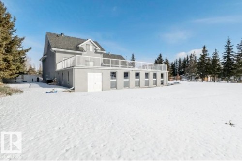 Expansive grounds featuring mature evergreen trees and a multi-level structure - 18633 122 Avenue, Edmonton, AB - Outdoor