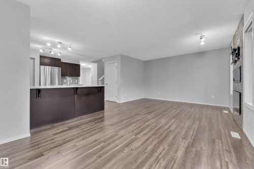 Spacious main living area featuring wide plank wood-finish flooring and light gray painted walls - 718 177 Street, Edmonton, AB - Indoor
