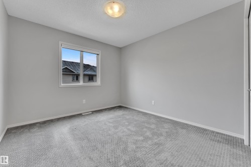Room featuring light gray walls, gray patterned carpeting, and white baseboards - 718 177 Street, Edmonton, AB - Indoor Photo Showing Other Room