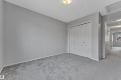 Neutral gray wall paint with white trim, gray carpet, and white bi-fold closet doors - 