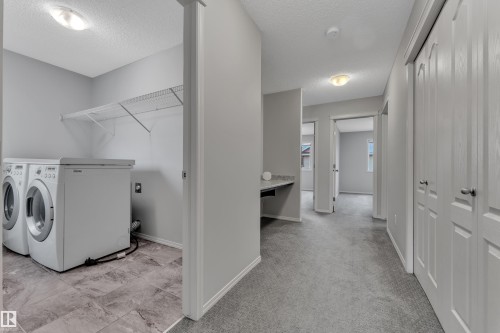 Dedicated laundry area with tile flooring and wire shelving - 718 177 Street, Edmonton, AB - Indoor Photo Showing Laundry Room