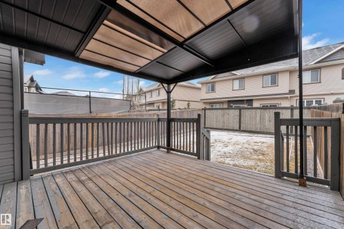 Expansive wooden deck with a built-in pergola featuring a retractable fabric canopy - 718 177 Street, Edmonton, AB - Outdoor With Deck Patio Veranda With Exterior
