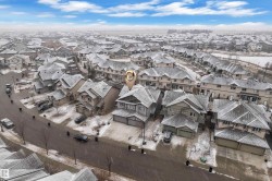 Aerial perspective of a residential street with multiple detached and attached homes - 